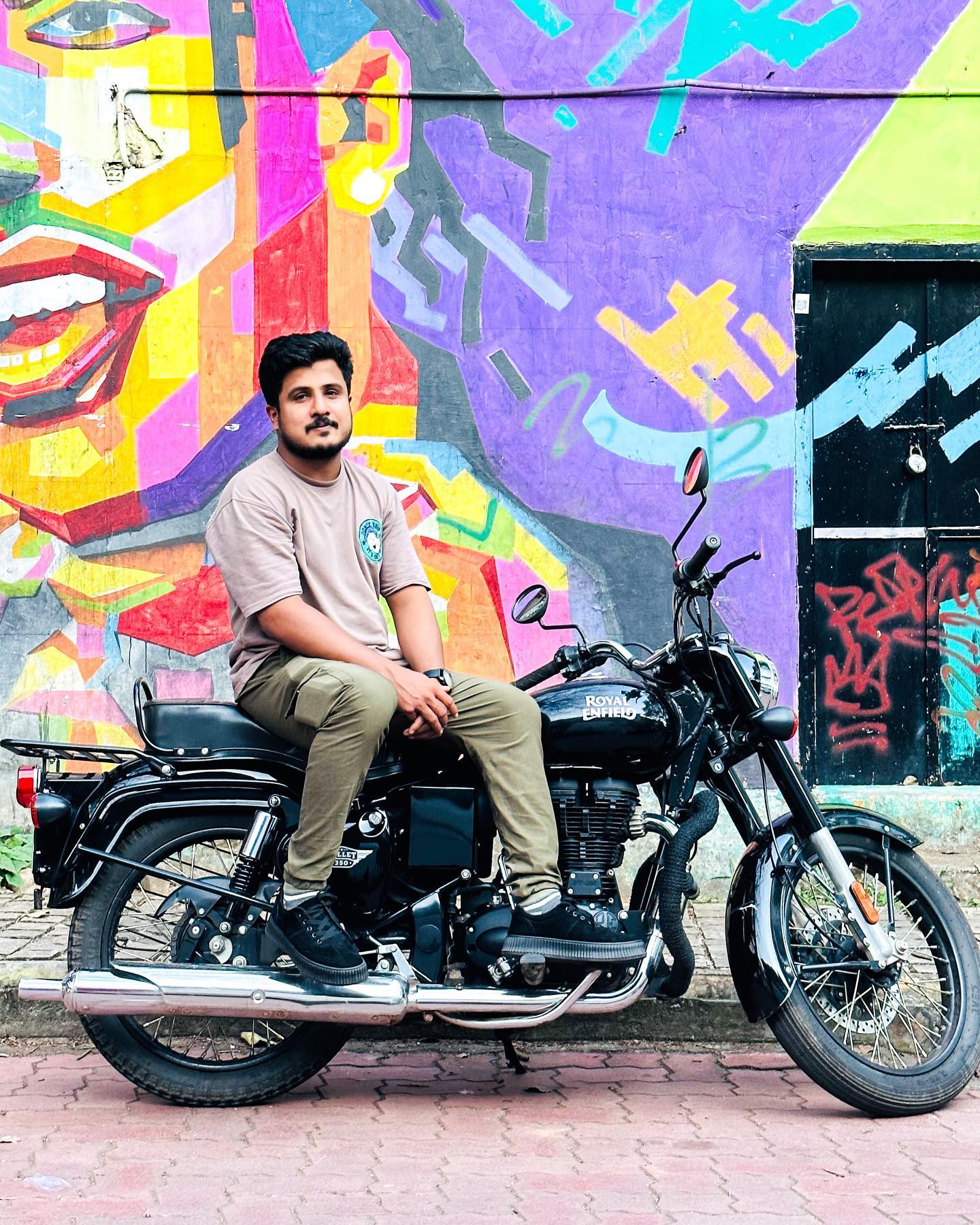 Man in black leather jacket and brown pants standing beside black  motorcycle during daytime photo – Free Motorcycle Image on Unsplash